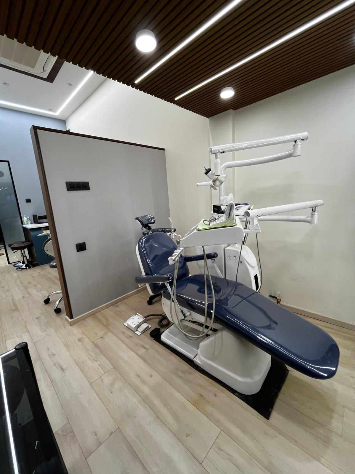 Samridhi Dental's main treatment room with modern chair and warm wood interior